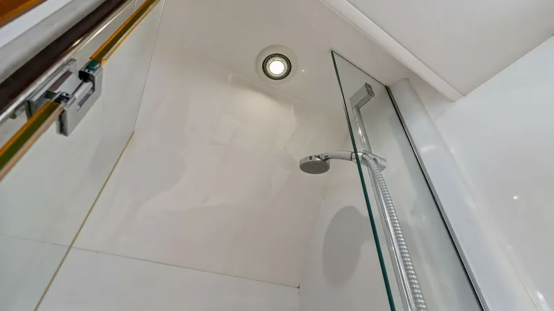 Slide: The Image of Crew Shower Enclosure This sleek shower enclosure on the 2016 Princess 64 Flybridge offers a modern and clean design, featuring high-quality glass doors and contemporary fixtures. The overhead recessed lighting provides ample illumination, enhancing the bright and airy feel of - 7460877