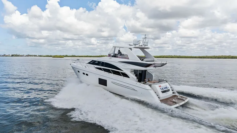 Slide: The Image of Dynamic Side View of Flybridge Cruiser This image captures the sleek profile of the 2016 Princess 64 Flybridge, showcasing its elegant design and powerful performance as it cuts through the water. The spacious flybridge is visible, offering ample seating and a commanding view, perfect for ente - 7460891