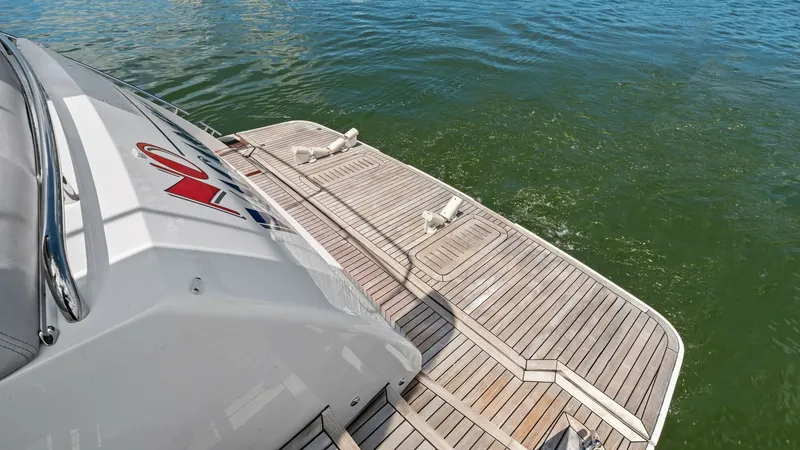 Slide: The Image of Teak Swim Platform View This image showcases the elegant teak swim platform of the 2016 Princess 64 Flybridge, 'No Vacansea'. The platform offers a spacious area for easy water access and relaxation, featuring high-quality teak decking that enhances the vessel's luxurious appeal - 7460804