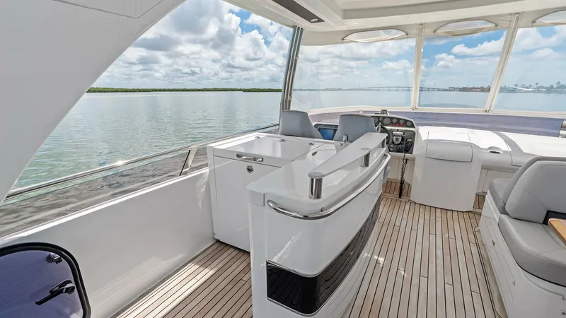 Slide: The Image of Flybridge Helm and Seating Area The flybridge of the 2016 Princess 64 offers a spacious helm station with an ergonomic design, providing excellent visibility for navigation. Luxurious seating surrounds the area, inviting relaxation while enjoying panoramic views. The teak decking adds a - 7460850