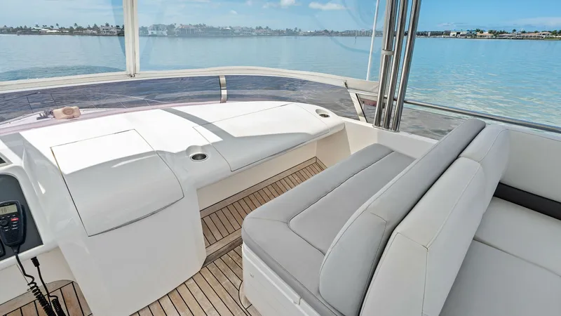 Slide: The Image of Flybridge Lounge Area with Seating This inviting flybridge on the 2016 Princess 64 offers ample seating with plush cushions, perfect for relaxation and socializing. The teak decking adds a touch of elegance while providing durability and style. Expansive views of the water enhance the luxu - 7460858