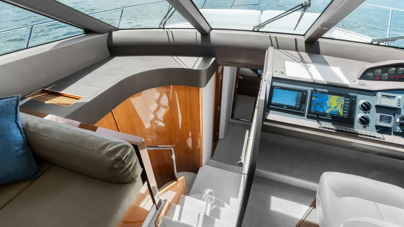 Slide: The Image of Flybridge Helm with Navigation Console This image showcases the helm of the Princess 64 Flybridge, featuring a state-of-the-art navigation console with dual screens for optimal control and visibility. The area is designed with a sleek, modern aesthetic, complemented by high-quality finishes an - 7460816