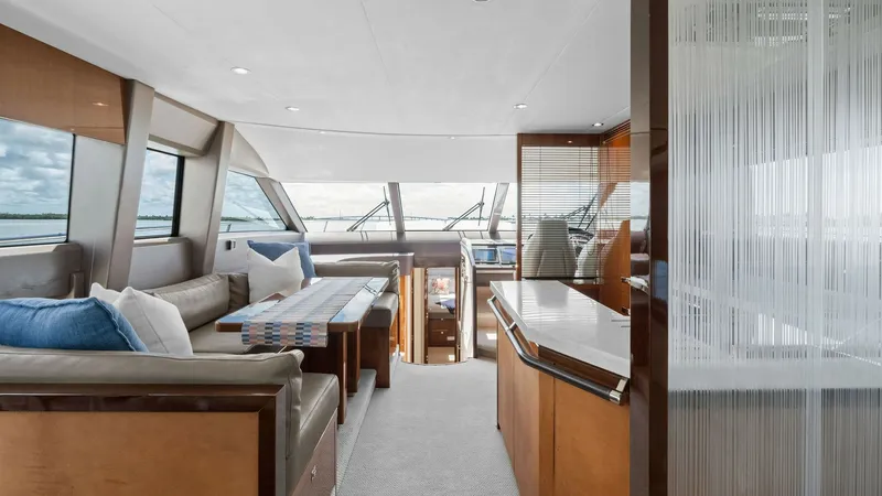 Slide: The Image of Spacious Salon with Panoramic Views The salon of the 2016 Princess 64 Flybridge offers a luxurious and comfortable space with expansive windows providing panoramic views. The elegant seating area is complemented by a stylish table, perfect for entertaining, while the high-quality finishes a - 7460813