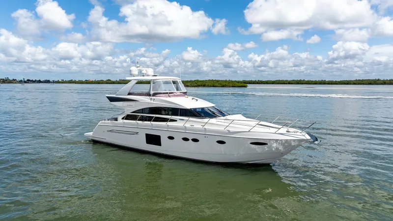 The Image of Profile View of 2016 Princess 64 Flybridge Yacht This image showcases the sleek and elegant profile of the 2016 Princess 64 Flybridge yacht, 'No Vacansea'. The vessel's aerodynamic design is complemented by large windows that provide ample natural light to the interior. The spacious flybridge offers an - 7460790