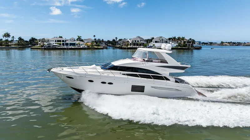Slide: The Image of Port Side Profile in Motion This stunning image captures the 2016 Princess 64 Flybridge, 'No Vacansea,' gliding smoothly through the water. The sleek profile showcases its aerodynamic design and spacious flybridge, highlighting the luxurious elegance that Princess Yachts are renowne - 7460890