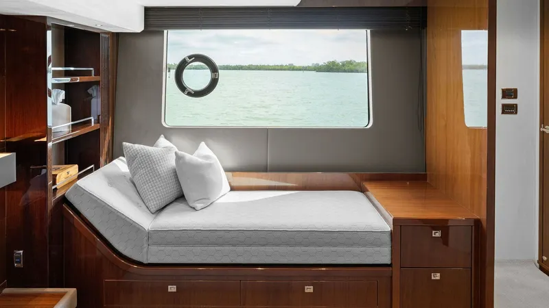 Slide: The Image of Starboard Master Stateroom with Ocean View This elegant guest stateroom on the starboard side of the 2016 Princess 64 Flybridge offers a serene escape with its panoramic ocean view through the large window. The room features a plush bed with luxurious linens, complemented by rich wood finishes and - 7460824