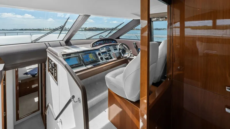 Slide: The Image of Sophisticated Helm Station The helm station of the 2016 Princess 64 Flybridge 'No Vacansea' features a sleek design with state-of-the-art navigation equipment. The ergonomic layout includes a plush captain's chair and panoramic windows for optimal visibility. Rich wood finishes and - 7460815
