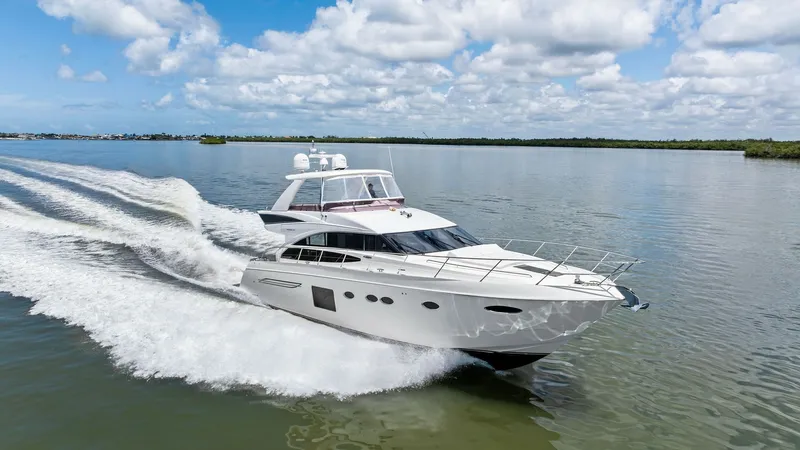Slide: The Image of Dynamic Bow View in Motion The 2016 Princess 64 Flybridge 'No Vacansea' showcases a sleek and powerful profile as it glides through the water. Its elegant hull design and stainless steel railings emphasize both luxury and performance. The expansive flybridge and aerodynamic lines a - 7460887