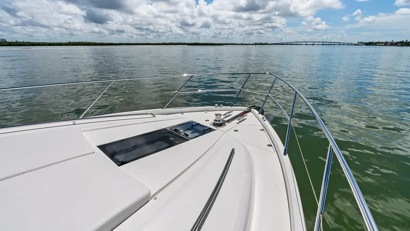 Slide: The Image of Bow Deck with Scenic View The bow deck of the 2016 Princess 64 Flybridge offers a spacious and sleek area perfect for relaxation while cruising. Stainless steel railings provide safety and style, complemented by a sunroof hatch that invites natural light into the cabin below. The - 7460864