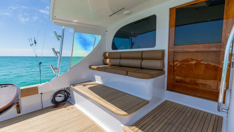 Slide: The Image of Teak Cockpit with Seating Area This inviting cockpit features elegant teak decking and a comfortable built-in seating area, perfect for relaxation or socializing. The rich wood finishes and ample space highlight the craftsmanship of the Blackwell 65 Convertible. Enjoy panoramic ocean v - 7469787