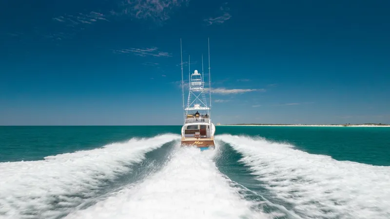 Slide: The Image of Aft View at Sea with Wake This dynamic aft view of the 2006 Blackwell 65 Convertible showcases the vessel's powerful performance as it glides across the ocean, leaving a distinctive wake behind. The sleek design and towering sportfishing tower emphasize its capability and elegance - 7469805