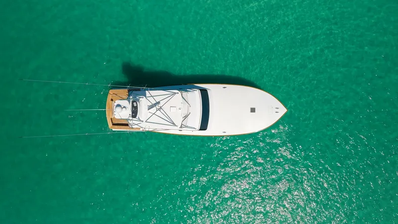 Slide: The Image of Aerial View of Open Deck This aerial shot showcases the sleek design and spacious open deck of the Blackwell 65 Convertible. The vessel's elegant lines and expansive bow are highlighted against the vibrant turquoise waters. Perfect for both leisure and sport, the layout offers am - 7469799