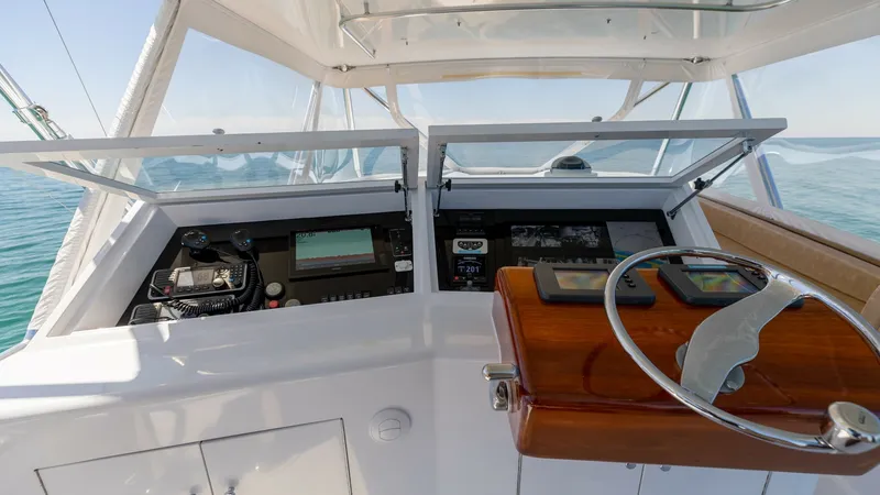 Slide: The Image of Helm Station with Dual Controls The helm station of the 2006 Blackwell 65 Convertible features dual control panels with advanced navigation systems and instruments. The polished wooden steering wheel and sleek design emphasize both functionality and style. Expansive windows provide exce - 7469770