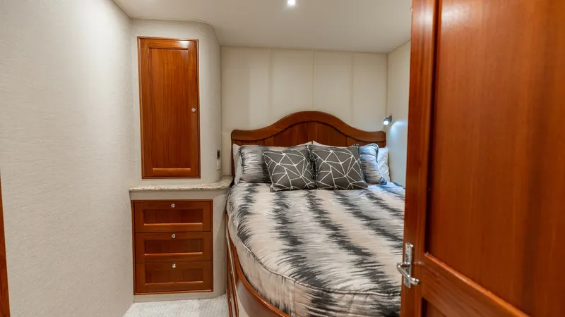 Slide: The Image of Guest Stateroom with Double Berth This inviting guest stateroom features a cozy double berth framed by rich wood paneling and elegant cabinetry. Soft overhead lighting enhances the warm, welcoming atmosphere, while the built-in storage offers practicality and convenience. The stylish bedd - 7469754