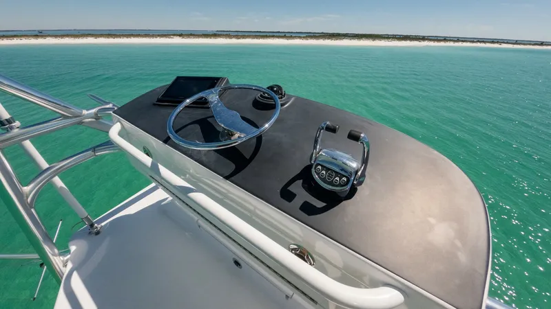 Slide: The Image of Flybridge Helm Station View This image showcases the sophisticated helm station on the flybridge of the 2006 Blackwell 65 Convertible. Featuring a sleek steering wheel and modern throttle controls, the design ensures optimal navigation and handling. The elevated position provides ex - 7469780