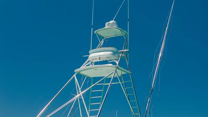 Slide: The Image of Tower with Dual Station and Antennas The image showcases the sleek and functional tower of the 2006 Blackwell 65 Convertible, featuring dual helm stations for optimal visibility and control. The polished metal framework elegantly supports advanced radar and communication antennas, ensuring s - 7469777