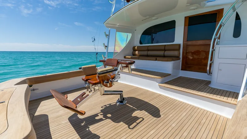 Slide: The Image of Spacious Aft Deck with Fishing Chair The aft deck of the Blackwell 65 Convertible features a beautifully crafted teak floor, offering a luxurious and durable surface. Equipped with a professional-grade fishing chair, this space is perfect for avid anglers. The comfortable built-in seating pr - 7469786