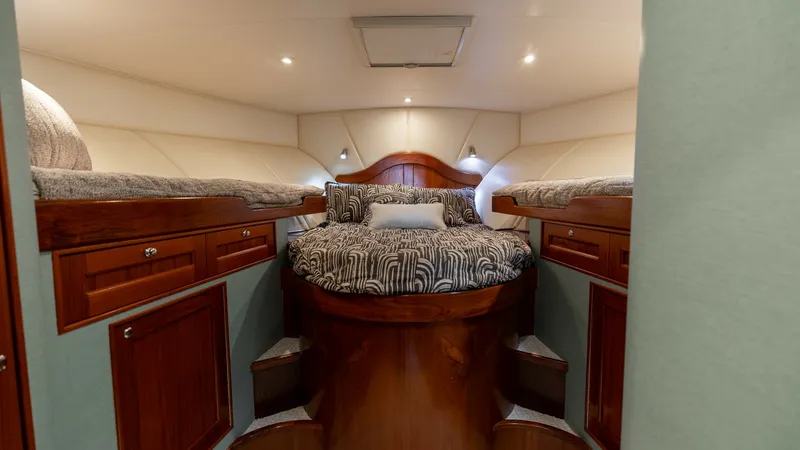 Slide: The Image of Forward Stateroom with Twin Berths This cozy forward stateroom features elegant twin berths with plush bedding and warm wood finishes. The built-in cabinetry offers ample storage space, complementing the room's inviting atmosphere. Soft ambient lighting and a central ceiling fixture enhanc - 7469760