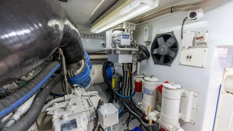 Slide: The Image of Engine Room with Mechanical Systems The engine room of the 2006 Blackwell 65 Convertible showcases a well-organized array of mechanical systems. Visible are the robust piping and filtration systems, ensuring optimal performance and reliability. The bright lighting and efficient layout facil - 7469795