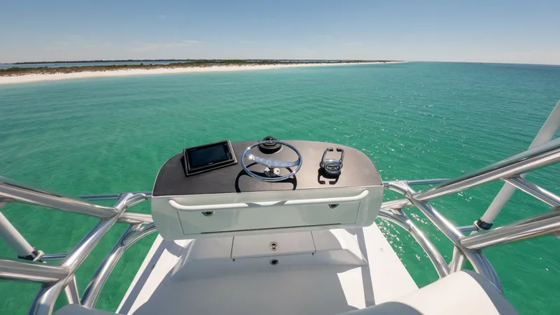 Slide: The Image of Flybridge Helm Station View This image showcases the helm station on the flybridge of the 2006 Blackwell 65 Convertible, MAE. The helm features a modern steering wheel, electronic navigation equipment, and unobstructed panoramic views of the surrounding sea. The polished metalwork a - 7469778