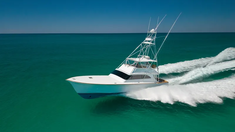 Slide: The Image of Aerial View of 65 Convertible Cruising This impressive Blackwell 65 Convertible from 2006 effortlessly slices through turquoise waters, showcasing its sleek lines and powerful design. The vessel's towering tuna tower and streamlined hull promise both performance and style, making it a standout - 7469803