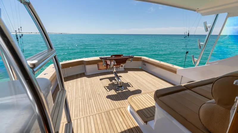 Slide: The Image of Spacious Teak Aft Deck with Seating The aft deck of the 2006 Blackwell 65 Convertible 'MAE' features a spacious teak flooring that exudes elegance and durability. A centrally positioned fighting chair offers an ideal spot for fishing enthusiasts, while the comfortable cushioned seating prov - 7469784