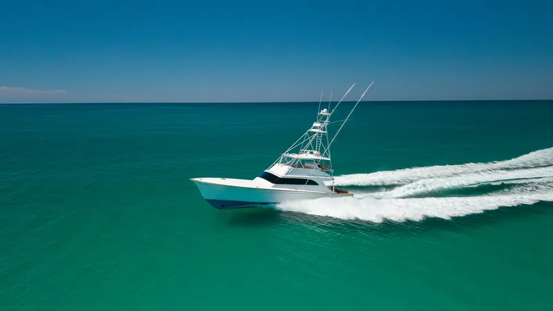 Slide: The Image of Aerial View of 65 Convertible This stunning aerial shot captures the sleek and powerful profile of the 2006 Blackwell 65 Convertible as it cruises effortlessly through pristine turquoise waters. The vessel's elegant design is complemented by its robust fishing tower and streamlined hu - 7469802
