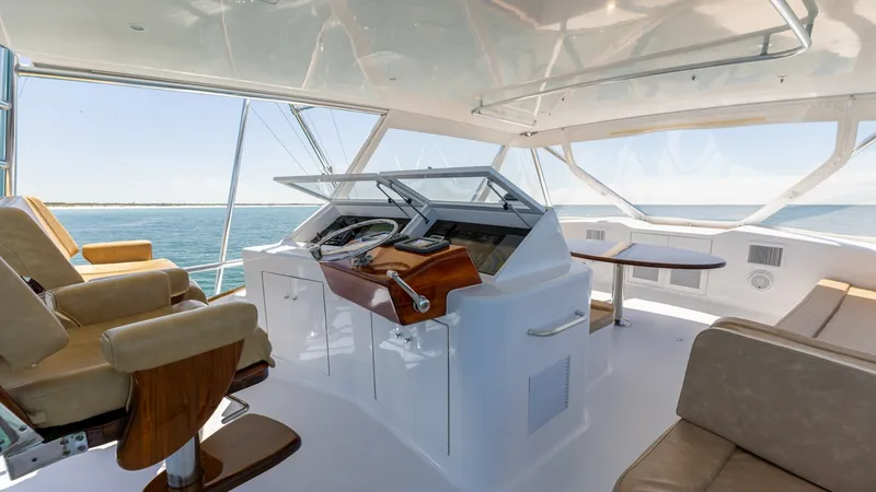 Slide: The Image of Flybridge Helm with Seating The flybridge of the 2006 Blackwell 65 Convertible offers a spacious helm with state-of-the-art navigation equipment and comfortable captain's chairs. The area is surrounded by large windows providing panoramic views, complemented by plush seating and a s - 7469772