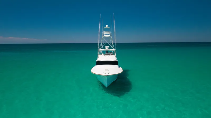 Slide: The Image of Bow View in Turquoise Waters The Blackwell 65 Convertible showcases its sleek bow against the stunning turquoise waters, emphasizing its elegant design and robust construction. The tower rises prominently, hinting at the vessel's sportfishing capabilities and providing an elevated va - 7469800