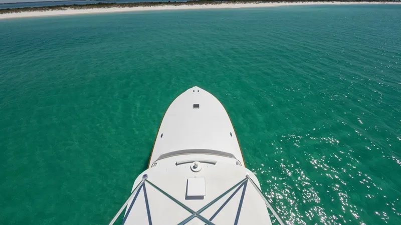 Slide: The Image of Bow View Overlooking Pristine Waters This striking aerial shot captures the sleek bow of the 2006 Blackwell 65 Convertible, MAE, as it glides through crystal-clear turquoise waters. The streamlined design and clean lines offer a modern, elegant aesthetic, while the expansive ocean view empha - 7469783