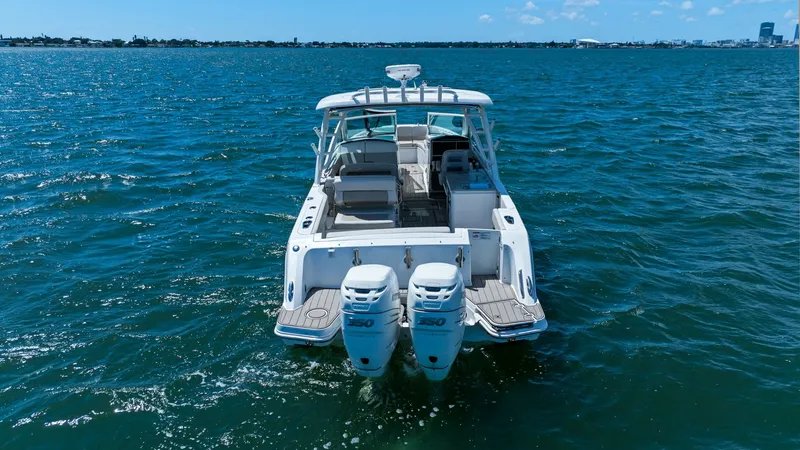 Slide: The Image of Aft View with Dual Engines This image showcases the aft view of the 2019 Boston Whaler 320 Vantage, featuring dual powerful outboard engines for superior performance. The spacious swim platform offers easy access to the water, perfect for recreational activities. Elegant seating ar - 7469851