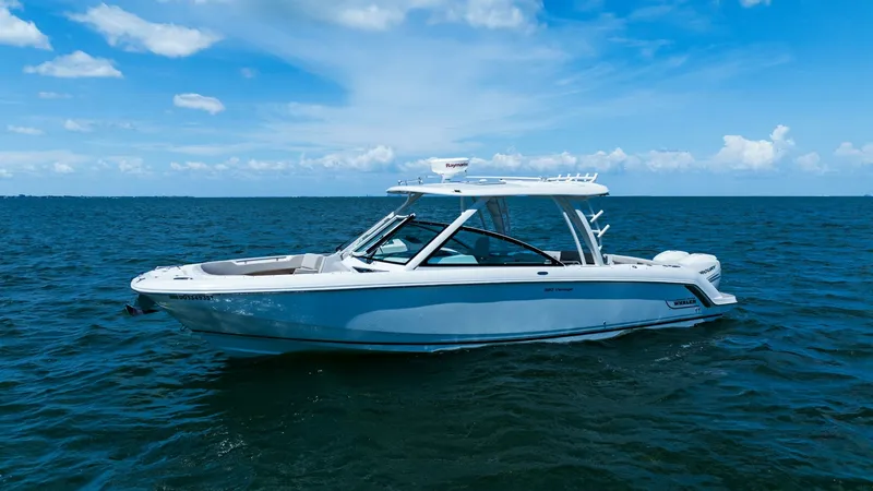 Slide: The Image of Side Profile on Open Water The 2019 Boston Whaler 320 Vantage is elegantly showcased against a sparkling ocean backdrop. This vessel boasts a sleek, modern design with a spacious deck and a sturdy hardtop, perfect for both leisure and adventure. Its clean lines and robust build ref - 7469847