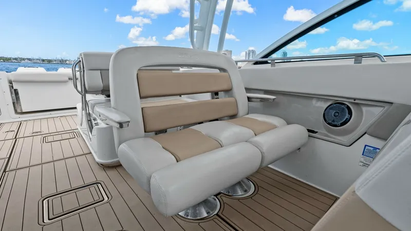 Slide: The Image of Convertible Cockpit Seating Area The 2019 Boston Whaler 320 Vantage features a versatile cockpit seating area with plush, cushioned bench seats. The neutral tones of the upholstery complement the sleek, modern design, providing both comfort and style. With ample space and ergonomic desig - 7469822
