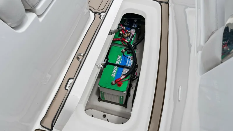 Slide: The Image of Battery Compartment in Deck Storage The image showcases the battery compartment within the deck storage of the 2019 Boston Whaler 320 Vantage. This compartment is neatly integrated into the deck, providing easy access to the vessel's power source while maintaining a clean and organized spac - 7469844