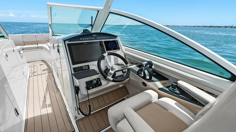 Slide: The Image of Helm Station with Dual Consoles The helm station of the 2019 Boston Whaler 320 Vantage features a sleek, modern design with dual consoles and state-of-the-art navigation systems. The ergonomic captain's chair offers comfort and control, while the expansive windshield provides excellent - 7469837