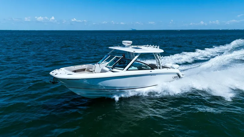 Slide: The Image of Boston Whaler 320 Vantage in Action The 2019 Boston Whaler 320 Vantage, named Thou Shell Knot, showcases its sleek profile and robust performance as it cruises effortlessly through open water. This dual-console vessel features a spacious cockpit, ample seating, and a stylish hardtop, ideal - 7469867