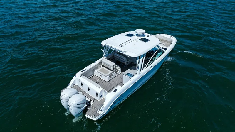 Slide: The Image of Aerial View of Aft Deck and Engines This aerial view showcases the spacious aft deck of the 2019 Boston Whaler 320 Vantage, 'Thou Shell Knot.' The deck features comfortable seating with high-quality finishes, ideal for socializing or relaxing. Twin outboard engines promise powerful performa - 7469860