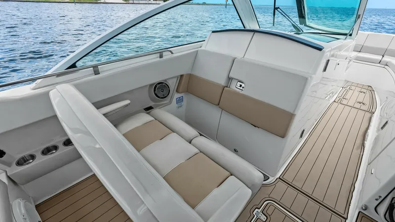 Slide: The Image of Cockpit Seating and Helm View This image showcases the versatile cockpit seating area on the Boston Whaler 320 Vantage. The plush, two-tone upholstery enhances comfort and style, while the spacious layout offers ample room for relaxation. The helm is visible, featuring a sleek windshi - 7469823