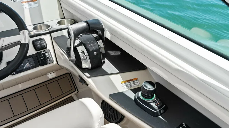 Slide: The Image of Helm Station with Controls The helm station of the 2019 Boston Whaler 320 Vantage features advanced controls and sleek design. The ergonomic throttle and joystick enhance maneuverability, while the console layout ensures ease of access to all functions. Premium materials and a pano - 7469838