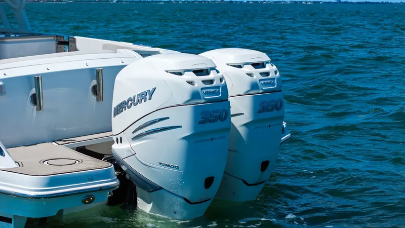 Slide: The Image of Twin Mercury Outboard Engines View This image showcases the powerful twin Mercury 350 outboard engines on the Boston Whaler 320 Vantage. These engines provide exceptional performance and reliability, ensuring smooth and efficient cruising. The sleek design and robust construction reflect t - 7469857