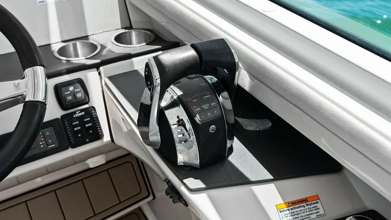 Slide: The Image of Helm Throttle Controls and Console This image showcases the helm throttle controls of the 2019 Boston Whaler 320 Vantage. The sleek, modern design features ergonomic levers and a user-friendly interface, perfectly integrated into the console. Notable elements include dual cup holders and i - 7469840
