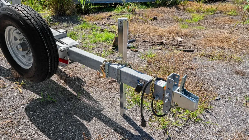 Slide: The Image of Boat Trailer Hitch and Tongue This image showcases the robust trailer hitch and tongue designed for secure towing. The galvanized steel construction ensures durability against the elements, while the coupling mechanism provides a reliable connection to your vehicle. The attached safet - 7469868