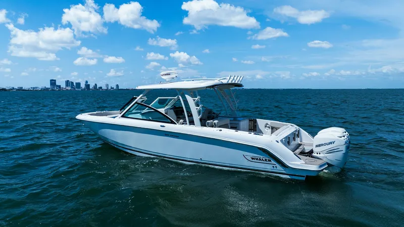 Slide: The Image of Starboard View of 320 Vantage This image showcases the starboard side of the 2019 Boston Whaler 320 Vantage, highlighting its sleek lines and robust design. The vessel features a spacious cockpit and is powered by twin Mercury engines, ensuring powerful performance on the water. Its e - 7469848
