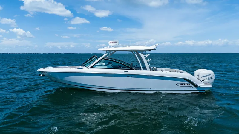 Slide: The Image of Side Profile on Open Water This image showcases the sleek side profile of the 2019 Boston Whaler 320 Vantage, 'Thou Shell Knot.' The vessel is elegantly designed with a modern hardtop and spacious deck, ideal for both leisure and adventure. The twin engines promise powerful perform - 7469849