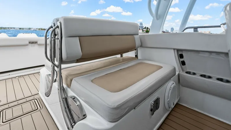Slide: The Image of Convertible Cockpit Seating Area This image showcases the versatile cockpit seating on the 2019 Boston Whaler 320 Vantage. The plush, dual-tone cushions provide comfortable seating with an adjustable backrest for flexibility. The teak decking adds an elegant touch, while the stainless st - 7469824