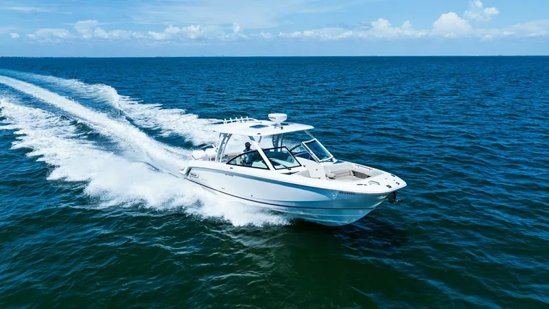 Slide: The Image of Dynamic Aerial View of Bow Experience the thrill of open water with the 2019 Boston Whaler 320 Vantage. Captured from above, this image showcases the vessel's sleek lines and robust performance as it cuts through the waves. The spacious bow area, coupled with the elegant hardtop, h - 7469861