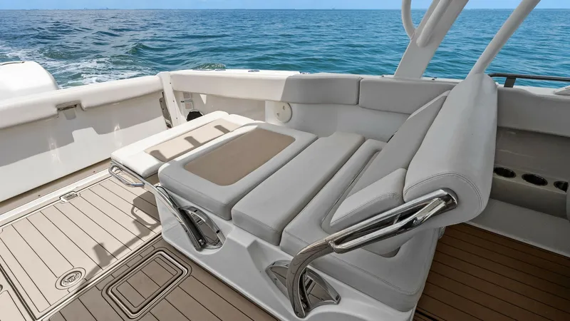 Slide: The Image of Convertible Aft Lounge Seating This image showcases the versatile aft lounge seating on the Boston Whaler 320 Vantage. The seating area is designed for comfort and functionality, featuring plush cushions and adjustable backrests that can be configured for relaxation or socializing. The - 7469827