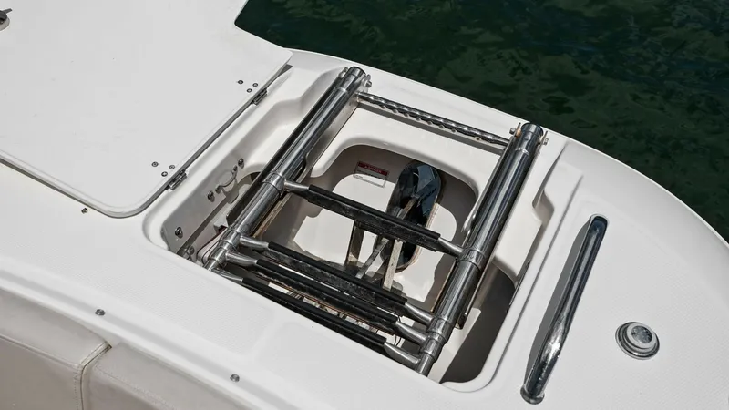 Slide: The Image of Swim Platform with Retractable Ladder This image showcases the sleek design of the swim platform on the 2019 Boston Whaler 320 Vantage. The integrated retractable ladder provides easy access to the water, enhancing the vessel's convenience and functionality. The stainless steel finish ensures - 7469833