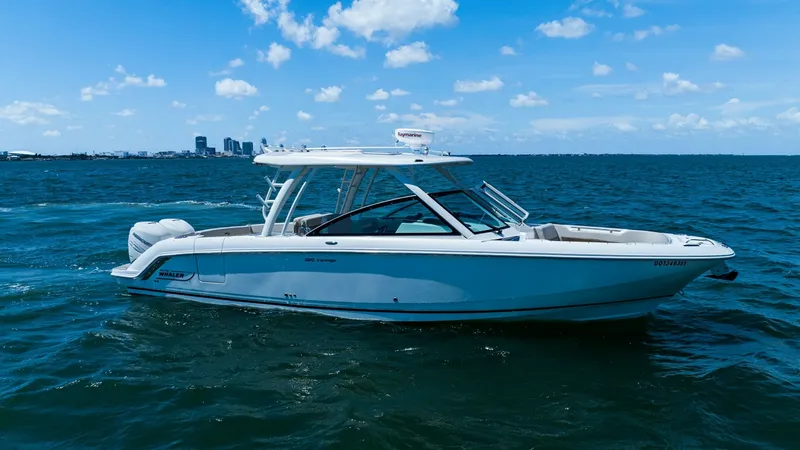Slide: The Image of Side Profile of Boston Whaler 320 Vantage The 2019 Boston Whaler 320 Vantage, known as 'Thou Shell Knot,' is showcased in this side profile view. The sleek hull design and spacious dual-console layout highlight its versatility and style. With its robust construction and ample seating, this vessel - 7469858