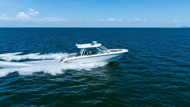 Slide: The Image of Boston Whaler 320 Vantage in Motion The 2019 Boston Whaler 320 Vantage, 'Thou Shell Knot', is pictured cruising effortlessly across open waters. With its sleek hull design and powerful outboard engines, this vessel offers a perfect blend of performance and luxury. The spacious cockpit and p - 7469856
